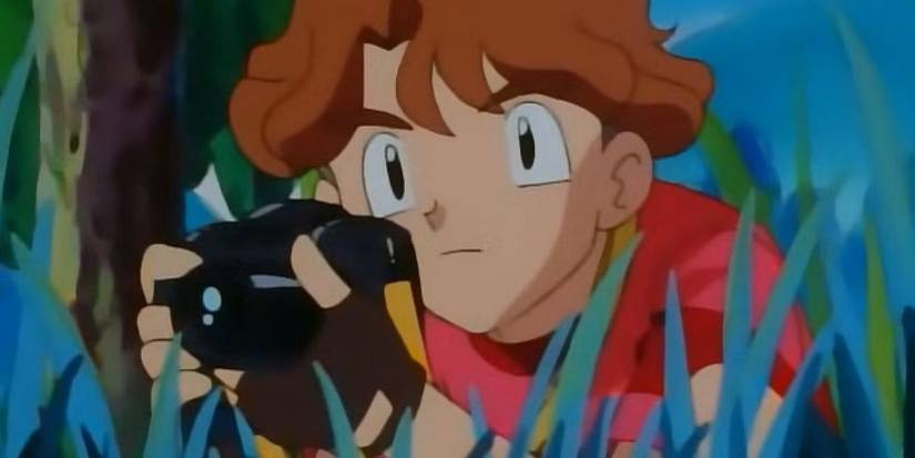 Todd Snaps hiding in the grass with his camera