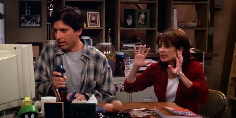 Ray Romano and Patricia Heaton sitting at a table in The Children's Book on Everybody Loves Raymond.