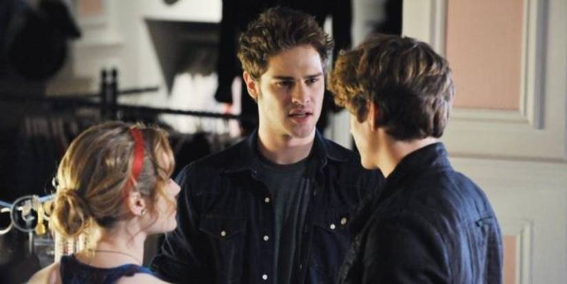 Grey Damon as Brian wearing a grey shirt and dark blue long sleeve in 'The Nine Lives of Chloe King.'