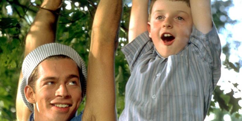 Adam Hann-Byrd and Harry Connick, Jr. as Fred and Eddie hanging off trees in Little Man Tate.
