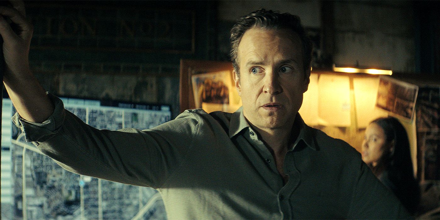 Rafe Spall as Burke pointing to his right in Apple TV+'s Smoke