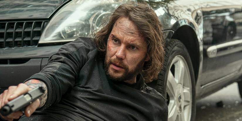 Ben Edwards (Taylor Kitsch) pulls a gun on 'The Terminal List: Dark Wolf.'