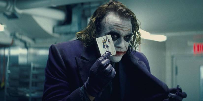 The Joker holds a Joker card in The Dark Knight.