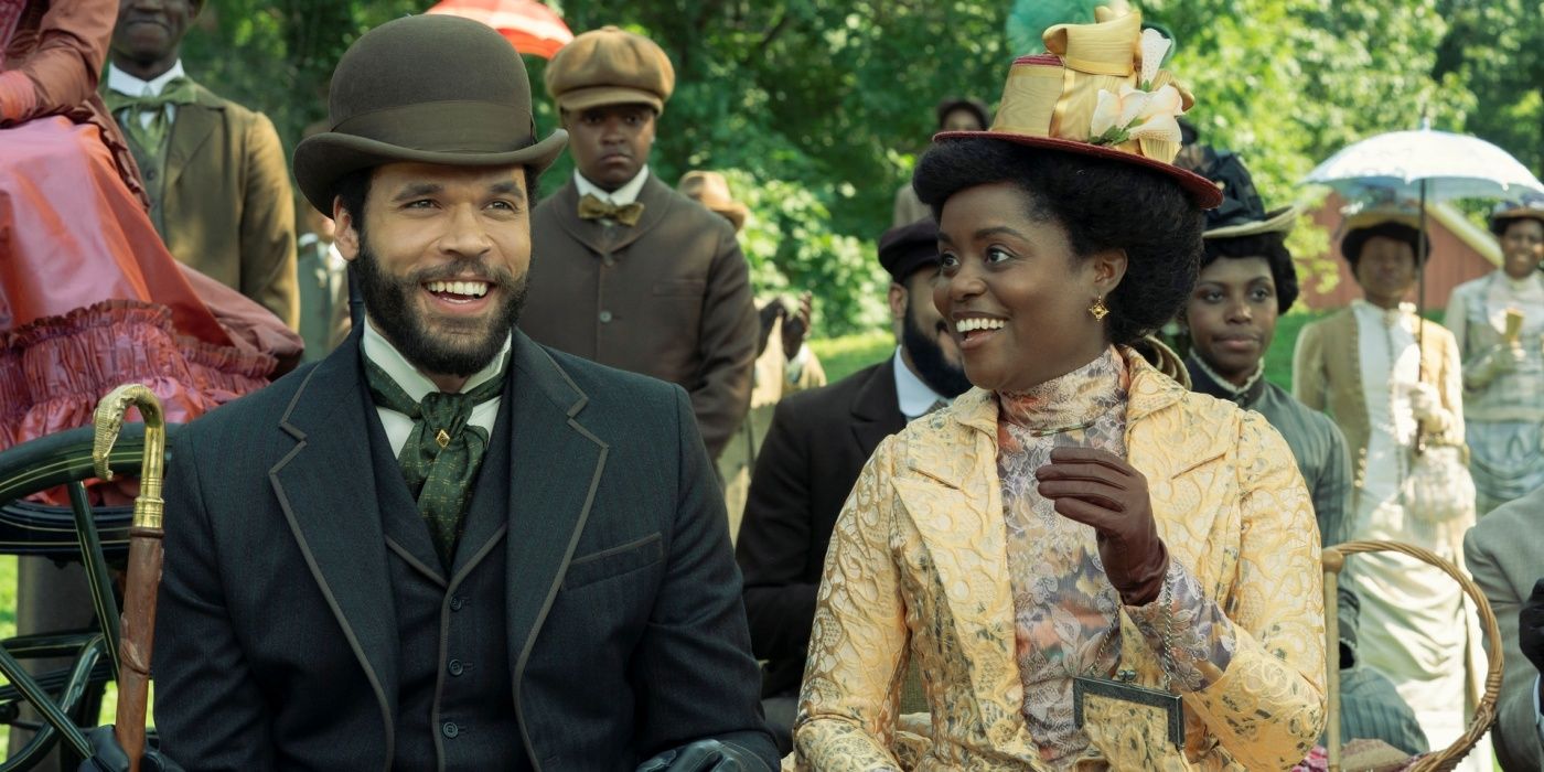 Jordan Donica as William sitting next to Denée Benton as Peggy smiling together in The Gilded Age Season 3.