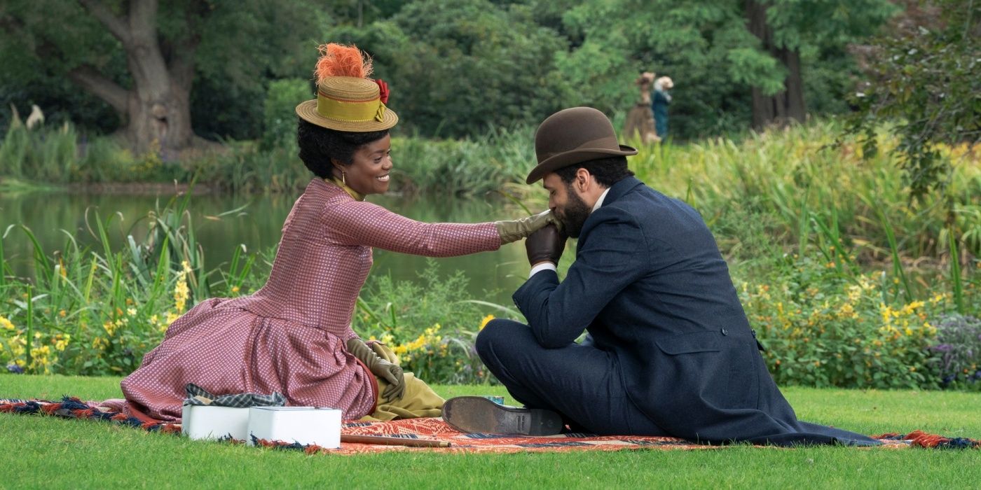 Denée Benton as Peggy on a picnic with Jordan Donica as William who is kissing her hand in The Gilded Age