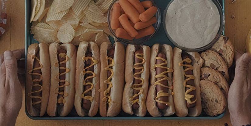 An array of food including chips, carrot sticks and seven hot dogs from Weapons