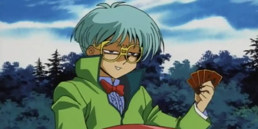 Weevil Underwood holding five duel monsters cards
