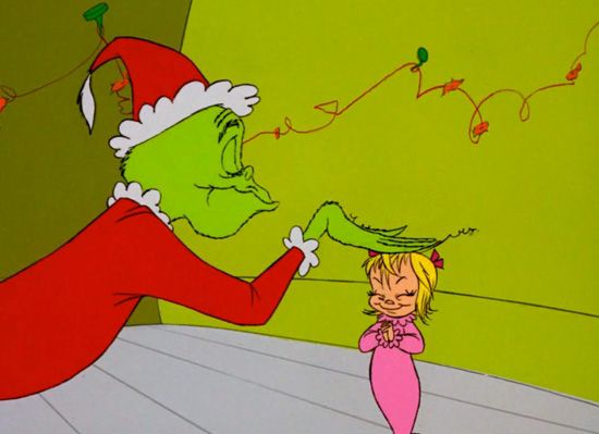 The Grinch patting Cindy Lou Who on her head in How the Grinch Stole Christmas