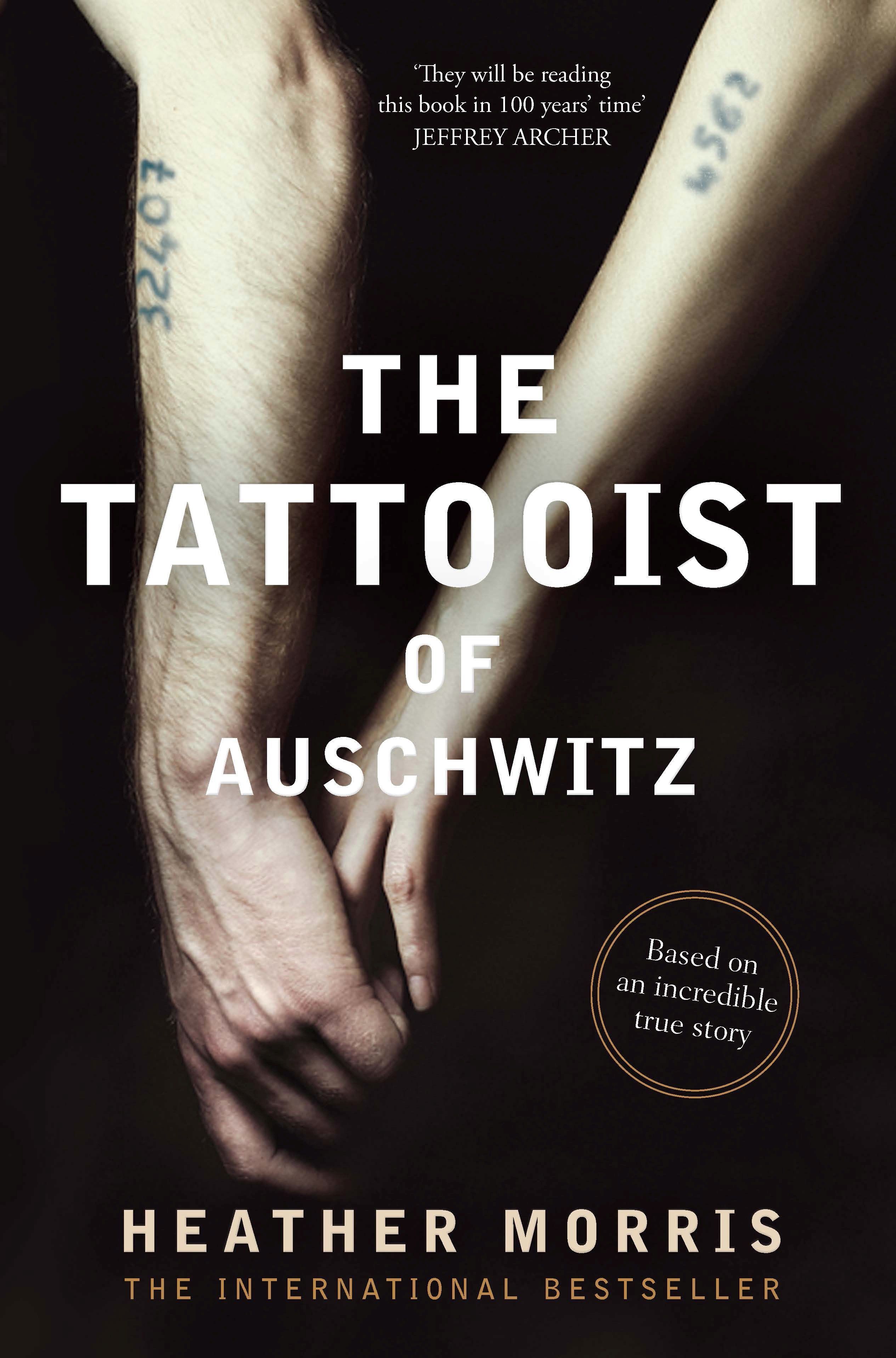 The Tattooist of Auschwitz Book Cover Showing Two People with Numbered Arm Tattoos holding hands